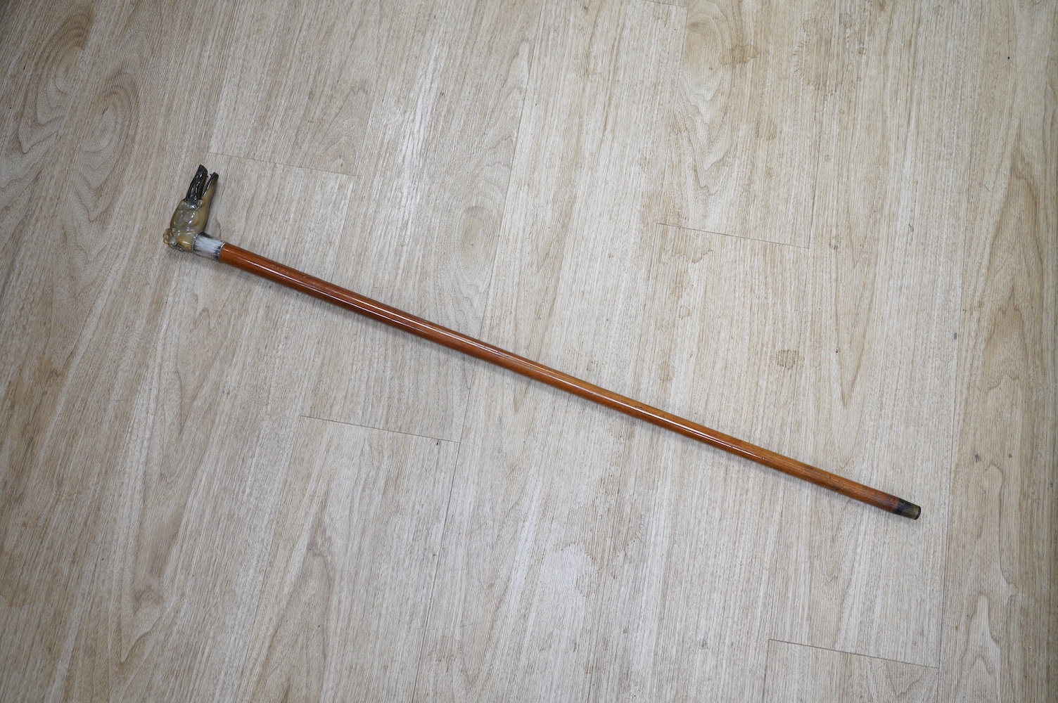 A carved horn ‘greyhound’ handled and silver collared Malacca walking cane, 90cm. Condition - fair to good